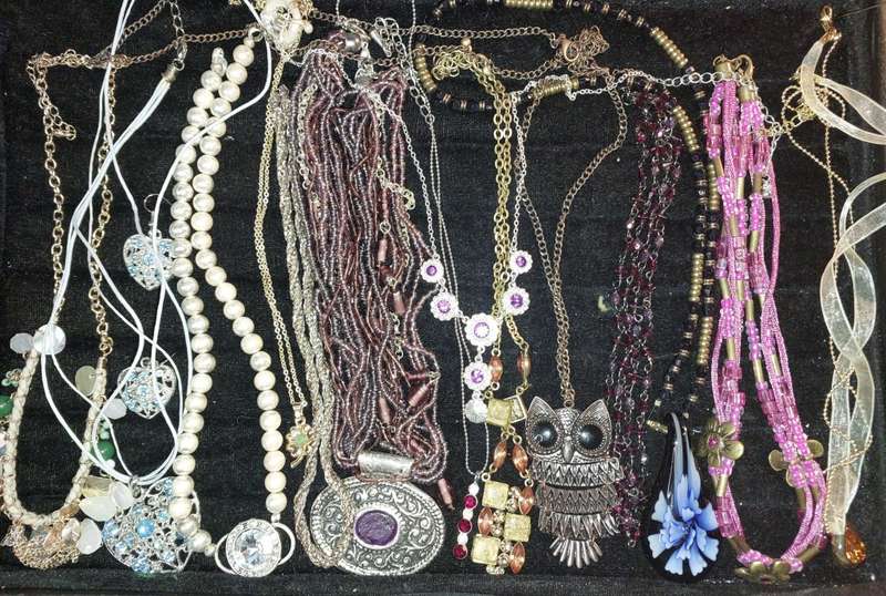 A BULK COLLECTION OF COSTUME JEWELRY AND THE PLASTIC CASES SOLD AS IS