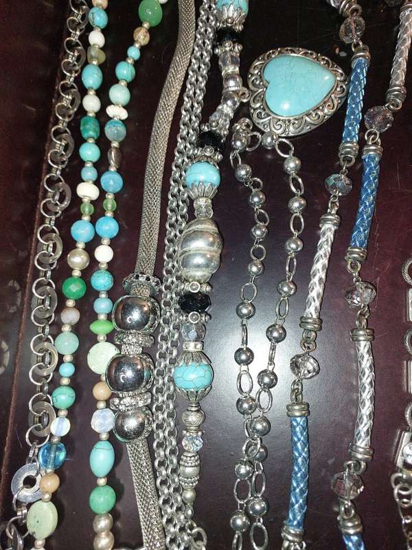 A BULK COLLECTION OF COSTUME JEWELRY AND THE PLASTIC CASES SOLD AS IS