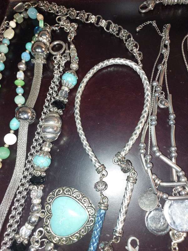A BULK COLLECTION OF COSTUME JEWELRY AND THE PLASTIC CASES SOLD AS IS