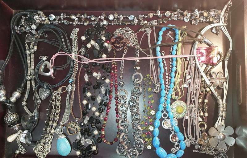 A BULK COLLECTION OF COSTUME JEWELRY AND THE PLASTIC CASES SOLD AS IS
