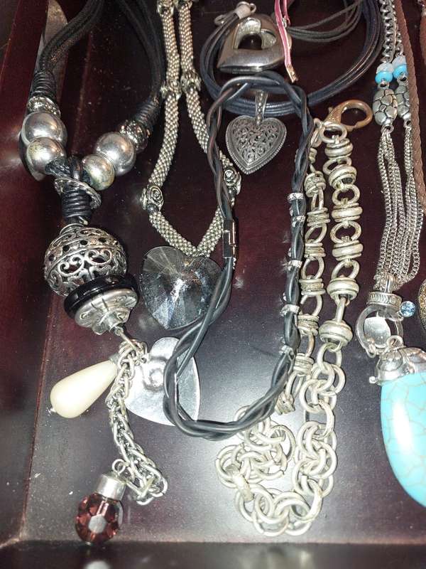 A BULK COLLECTION OF COSTUME JEWELRY AND THE PLASTIC CASES SOLD AS IS