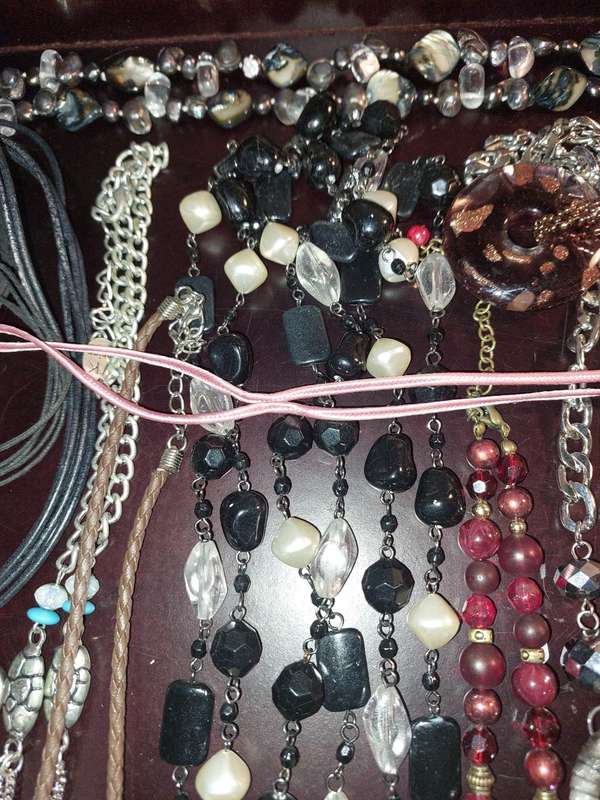 A BULK COLLECTION OF COSTUME JEWELRY AND THE PLASTIC CASES SOLD AS IS