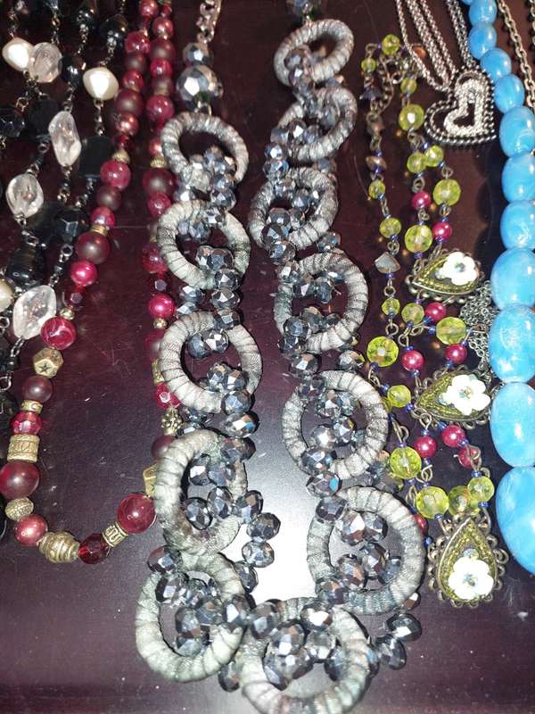 A BULK COLLECTION OF COSTUME JEWELRY AND THE PLASTIC CASES SOLD AS IS