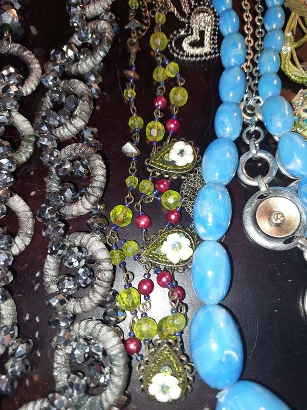 A BULK COLLECTION OF COSTUME JEWELRY AND THE PLASTIC CASES SOLD AS IS