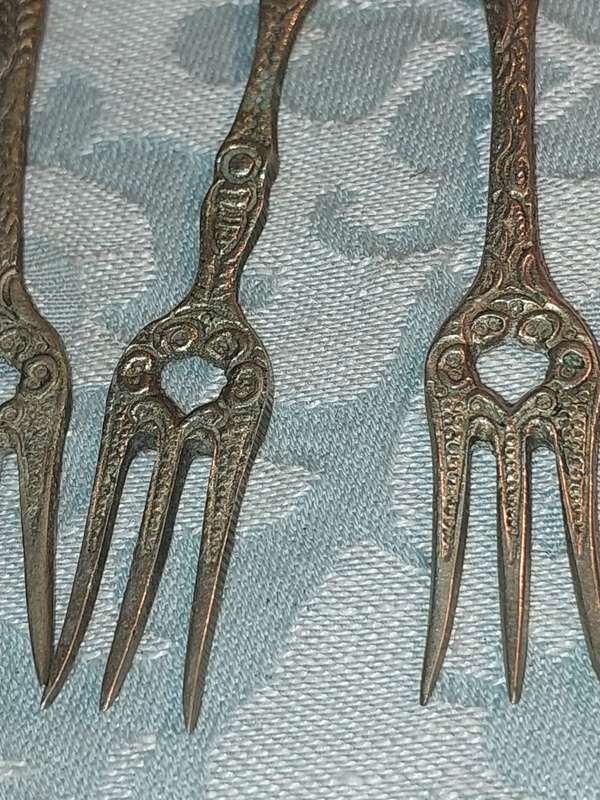 A COLLECTION OF ITALIAN PASTRY FORKS SOLD AS IS