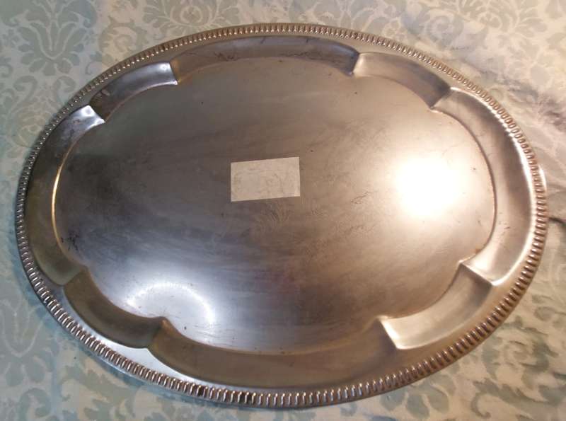 A VINTAGE STAINLESS STEEL SERVING TRAY NEEDS POLISHING