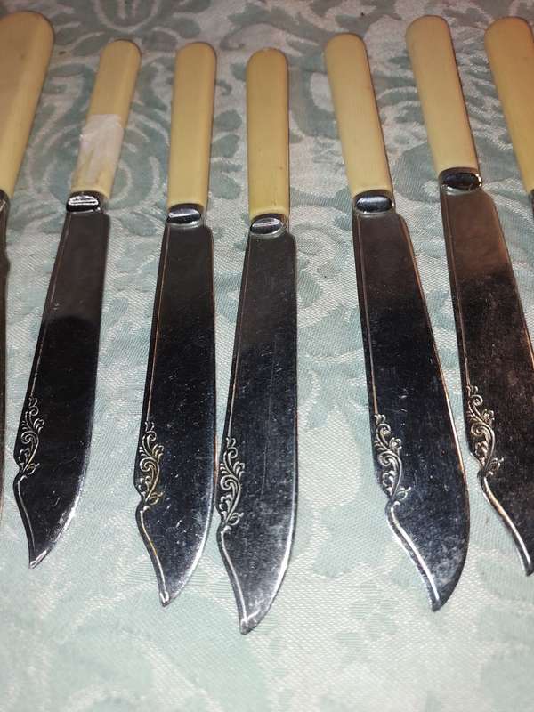 A COLLECTION OF BONE HANDLED CUTLERY SOLD AS IS