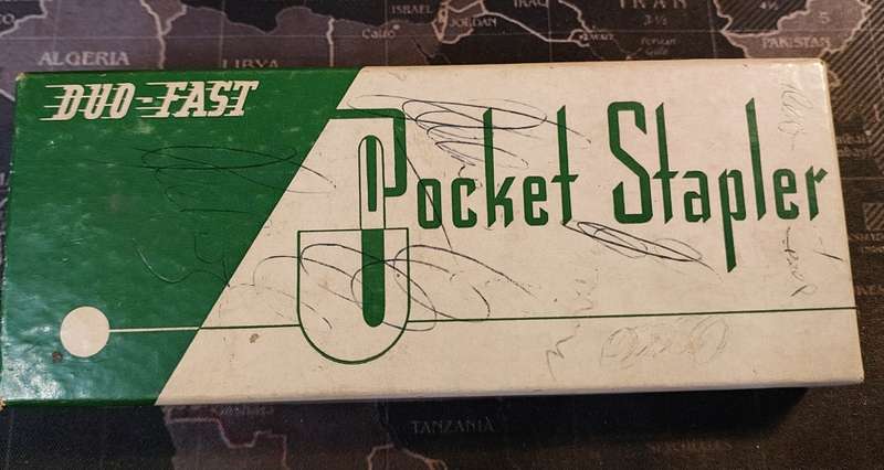 A VINTAGE POCKET STAPLER IN ITS ORIGINAL BOX