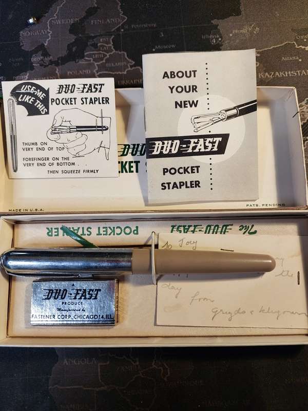 A VINTAGE POCKET STAPLER IN ITS ORIGINAL BOX