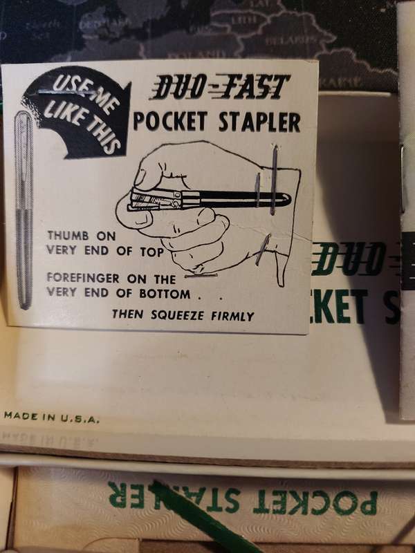 A VINTAGE POCKET STAPLER IN ITS ORIGINAL BOX