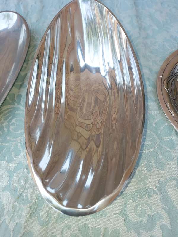 A  COLLECTION OF ALUMINIUM ALLOY PLATTERS  SOLD AS IS