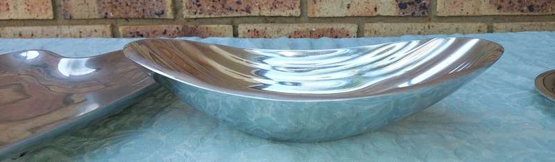 A  COLLECTION OF ALUMINIUM ALLOY PLATTERS  SOLD AS IS