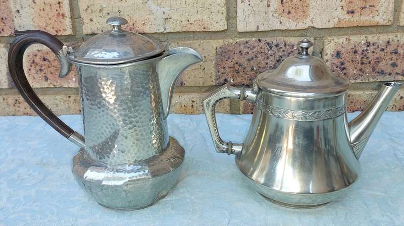 TWO ANTIQUE SILVER PLATED JUGS SOLD AS IS