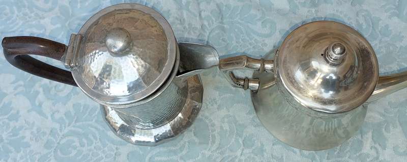 TWO ANTIQUE SILVER PLATED JUGS SOLD AS IS