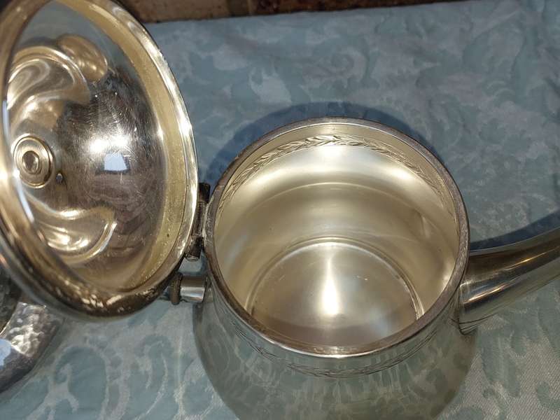 TWO ANTIQUE SILVER PLATED JUGS SOLD AS IS