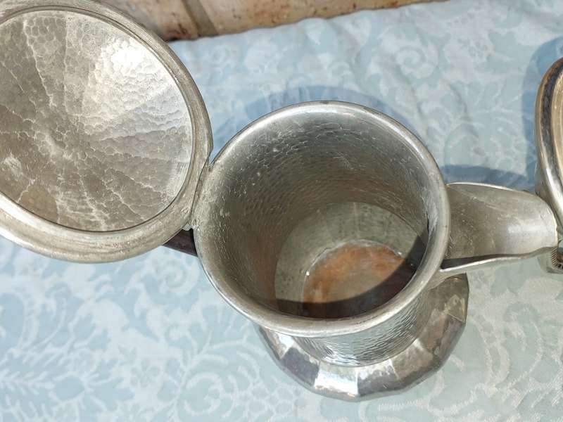 TWO ANTIQUE SILVER PLATED JUGS SOLD AS IS