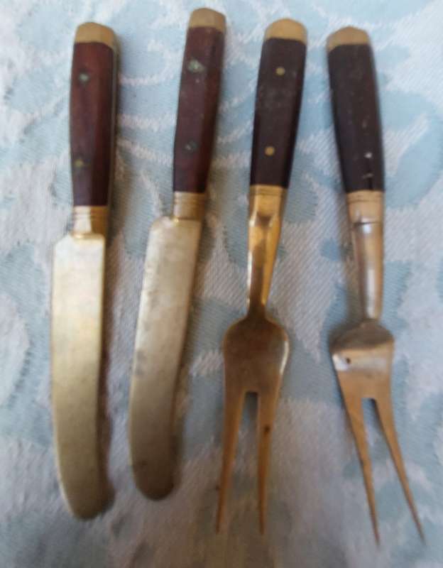 A SET OF FOUR BRASS AND WOOD KNIVES AND FORKS