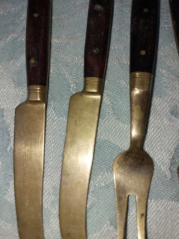 A SET OF FOUR BRASS AND WOOD KNIVES AND FORKS
