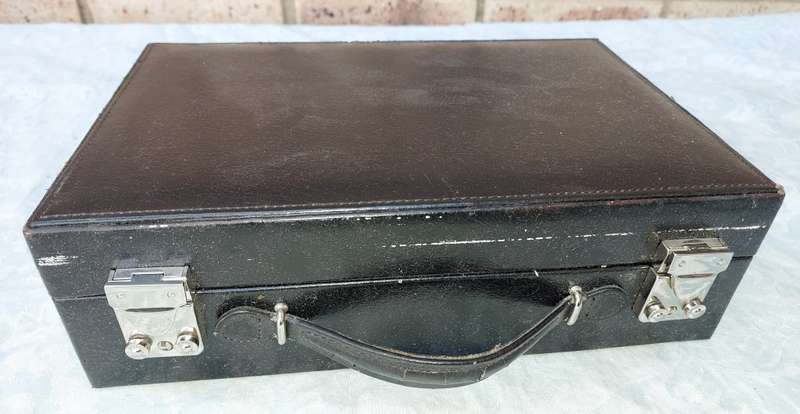 A NEAT BLACK LEATHER BOUND JEWELRY BOX