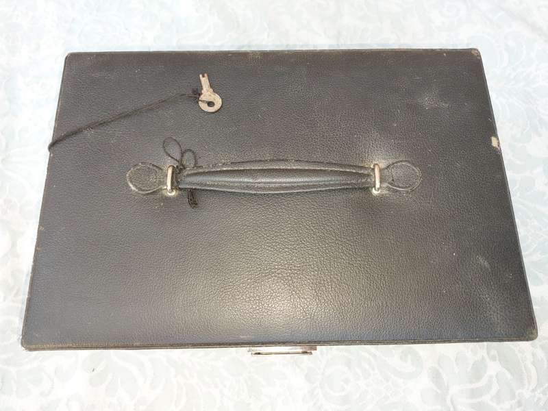 A LARGE BLACK LEATHER BOUND JEWELRY BOX SOLD AS IS