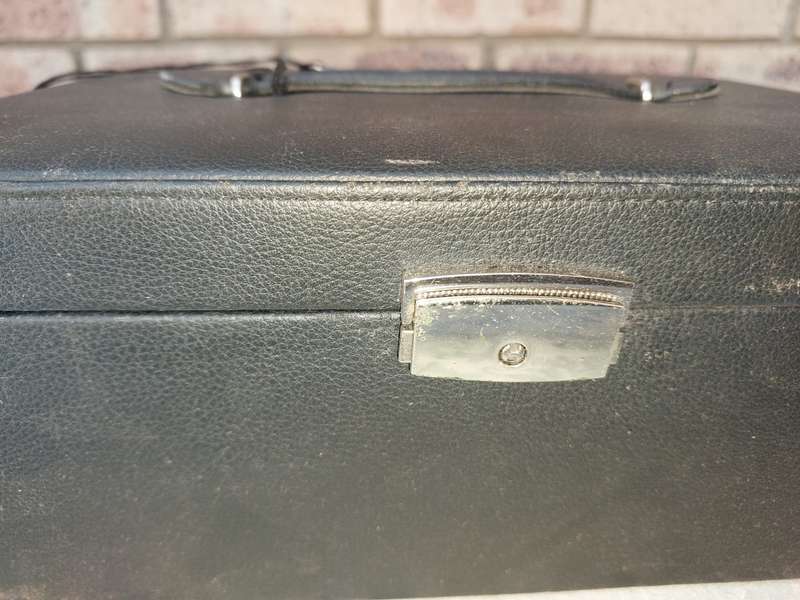 A LARGE BLACK LEATHER BOUND JEWELRY BOX SOLD AS IS