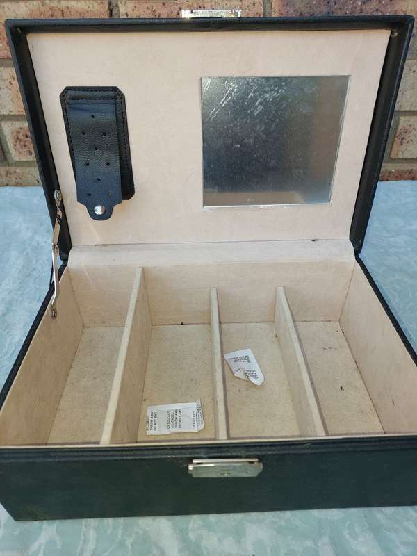 A LARGE BLACK LEATHER BOUND JEWELRY BOX SOLD AS IS