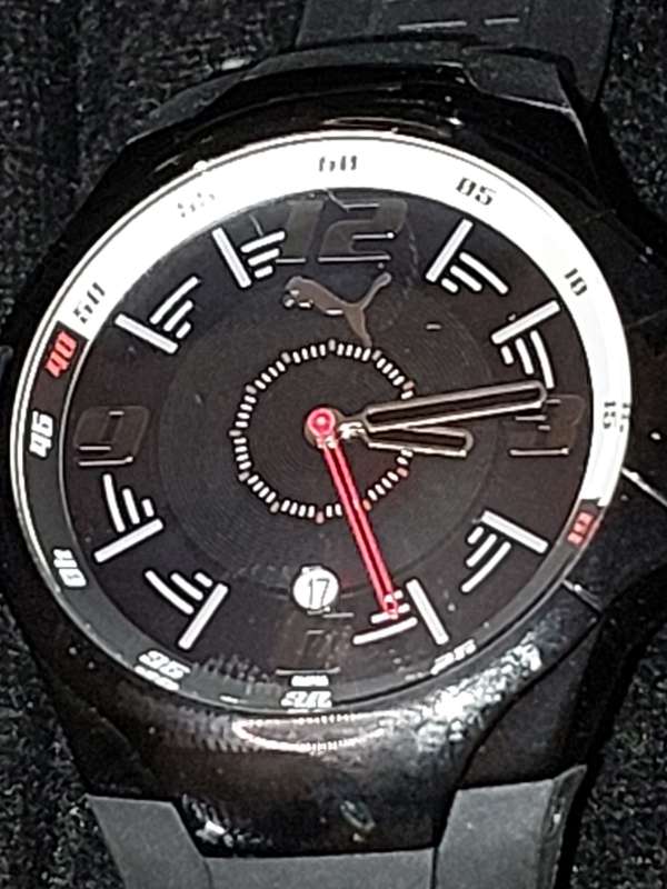 A Puma sports watch take pole position black with a rubber band