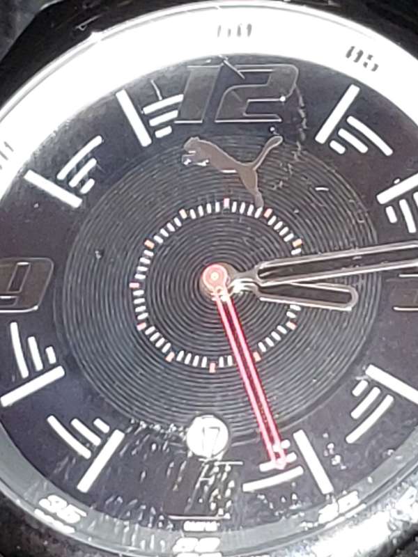 A Puma sports watch take pole position black with a rubber band