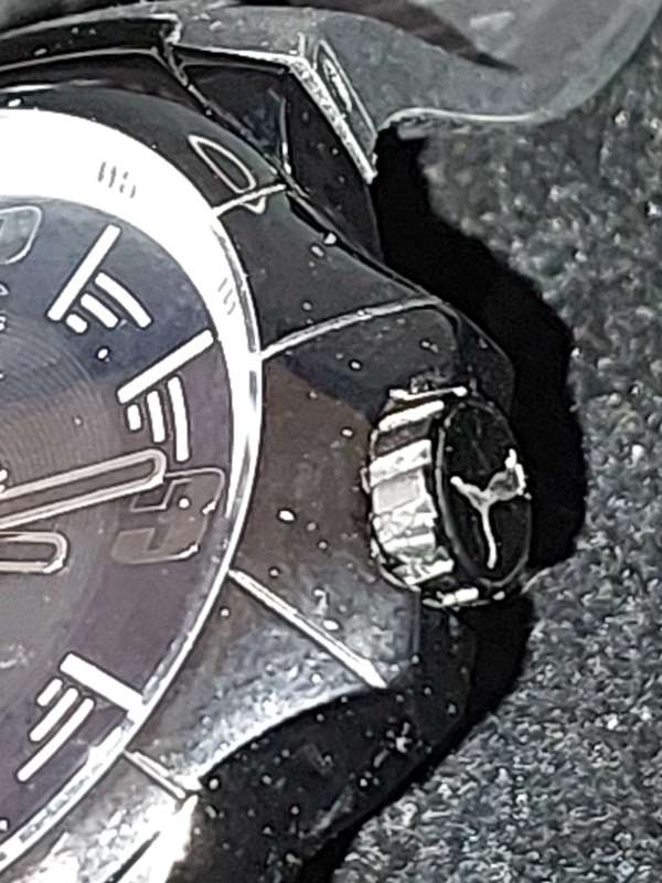 A Puma sports watch take pole position black with a rubber band