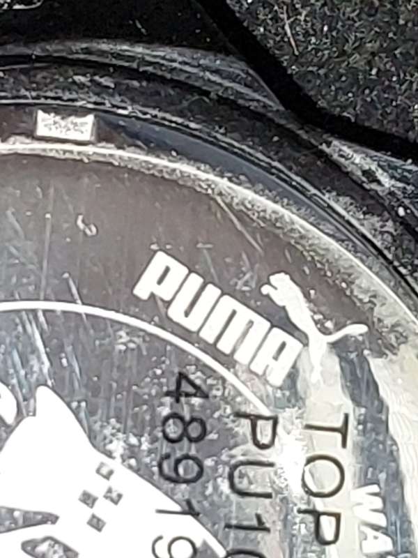A Puma sports watch take pole position black with a rubber band
