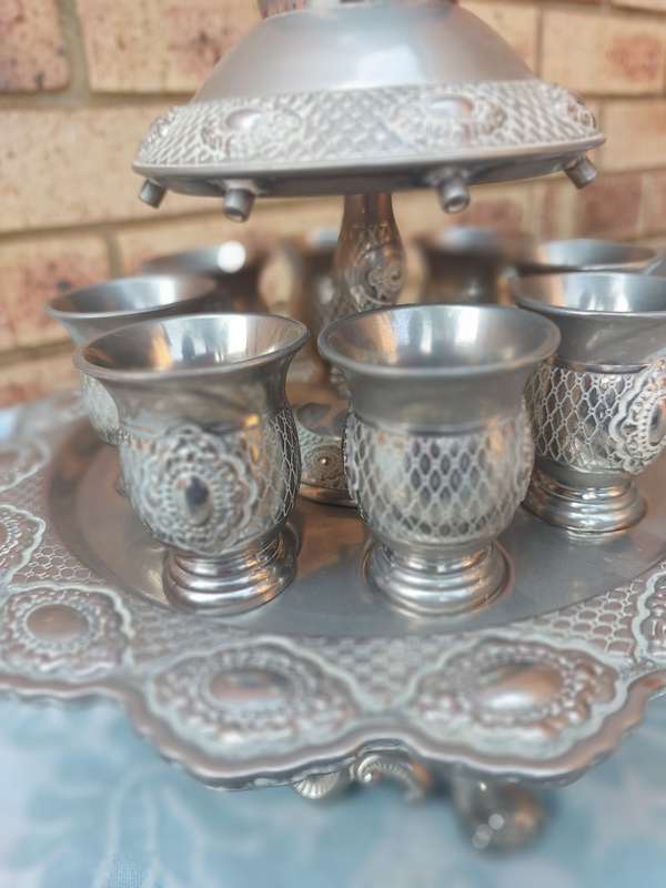 A COMPLETE ORNATE SILVER PLATED KIDDUSH CUP SET