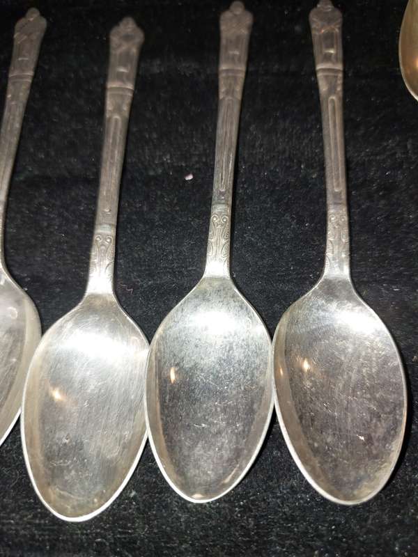 A COLLECTION OF 7 FIGURAL EPNS TEASPOONS