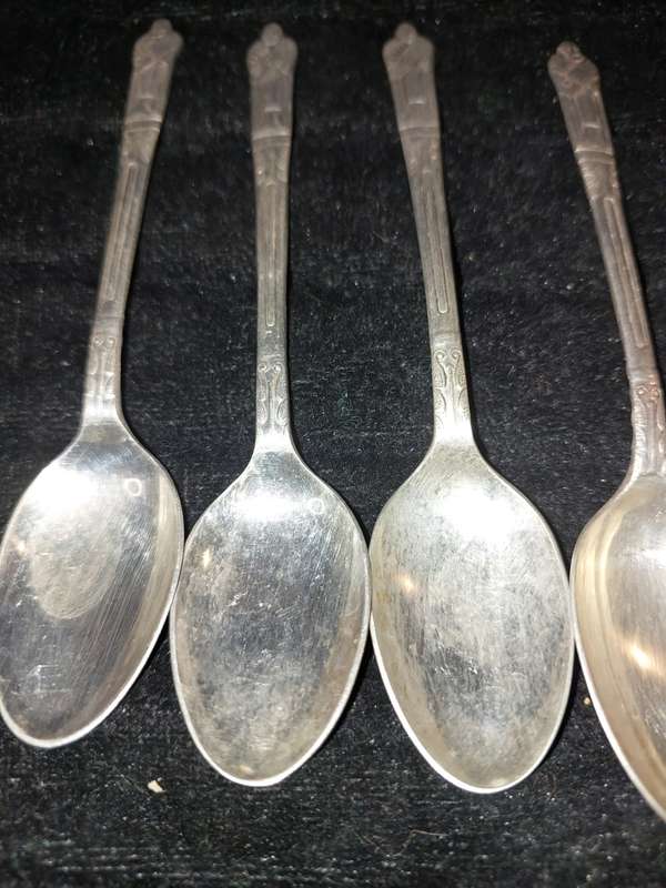 A COLLECTION OF 7 FIGURAL EPNS TEASPOONS