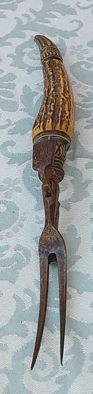 AN ANTIQUE ROAST FORK SOLD AS IS