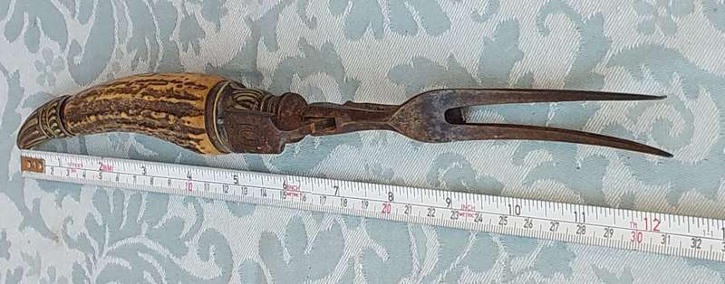 AN ANTIQUE ROAST FORK SOLD AS IS