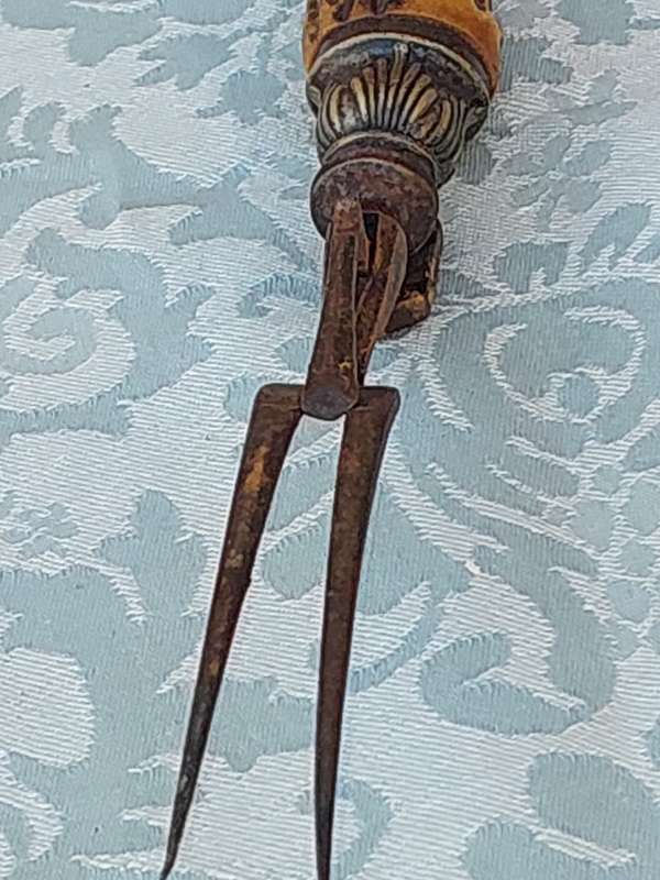 AN ANTIQUE ROAST FORK SOLD AS IS
