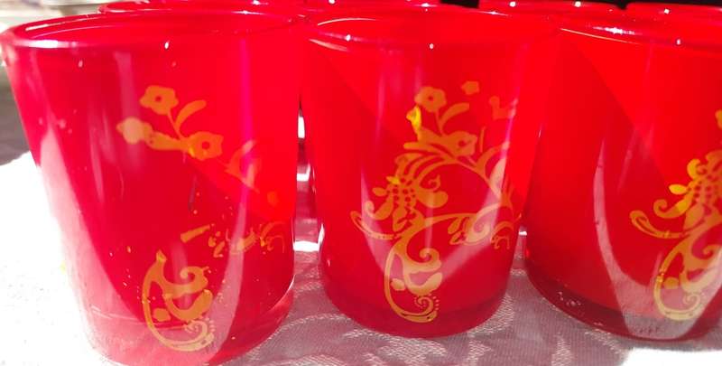 A COLLECTION OF 12 RED CANDLE HOLDER GLASSES