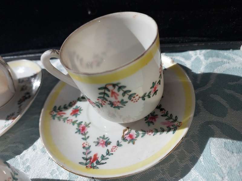 A COLLECTION OF HAND PAINTED TEA CUPS AND SAUCERS