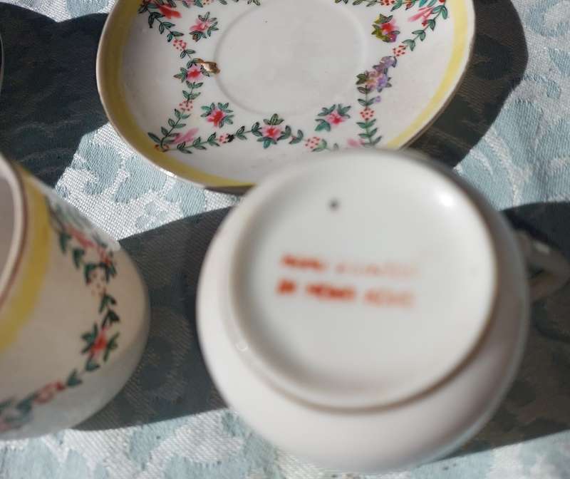 A COLLECTION OF HAND PAINTED TEA CUPS AND SAUCERS