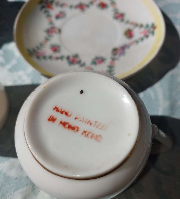 A COLLECTION OF HAND PAINTED TEA CUPS AND SAUCERS