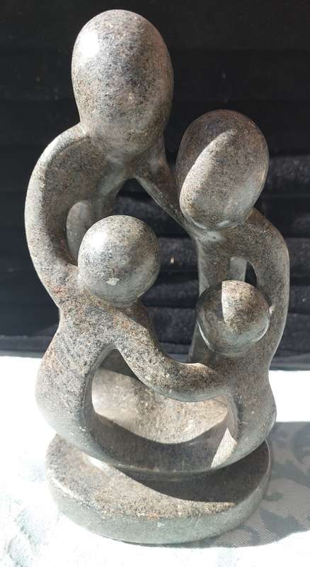 A GRANITE SHONA FAMILY OF 4 SCULPTURE