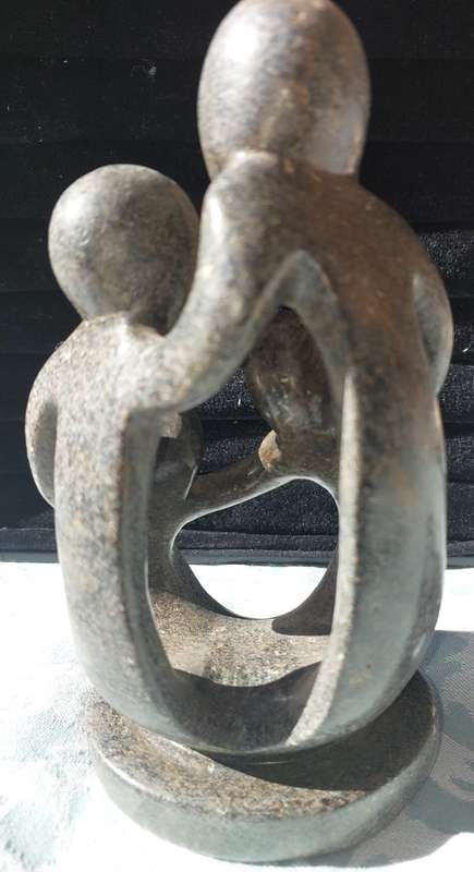 A GRANITE SHONA FAMILY OF 4 SCULPTURE