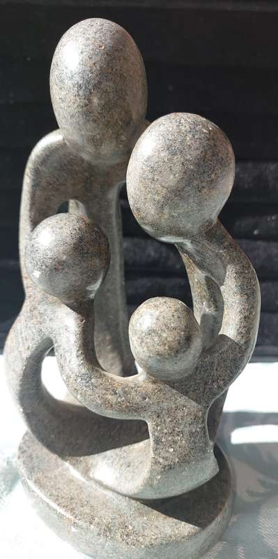 A GRANITE SHONA FAMILY OF 4 SCULPTURE