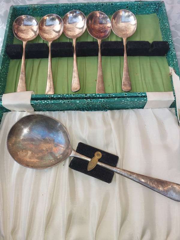 AN ANTIQUE SET OF SPOONS SOLD AS IS