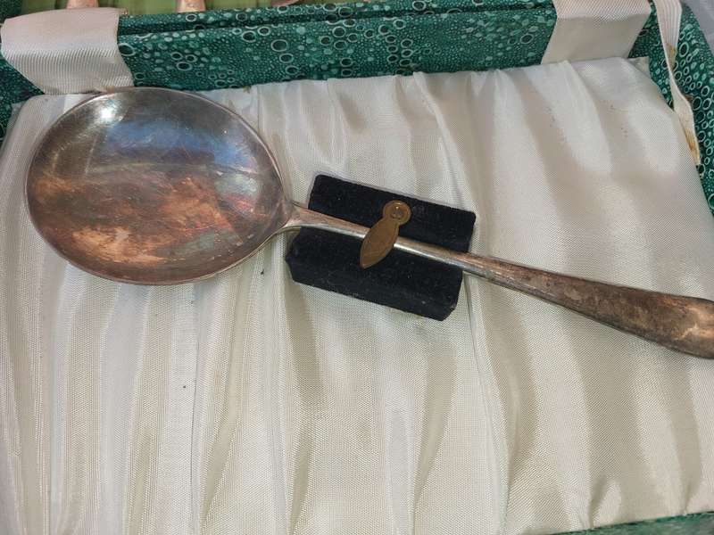 AN ANTIQUE SET OF SPOONS SOLD AS IS