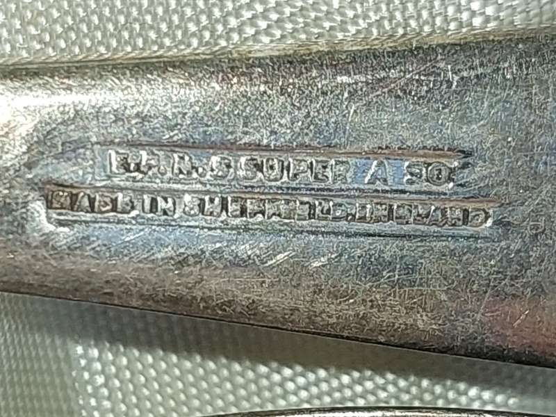 AN ANTIQUE SET OF SPOONS SOLD AS IS