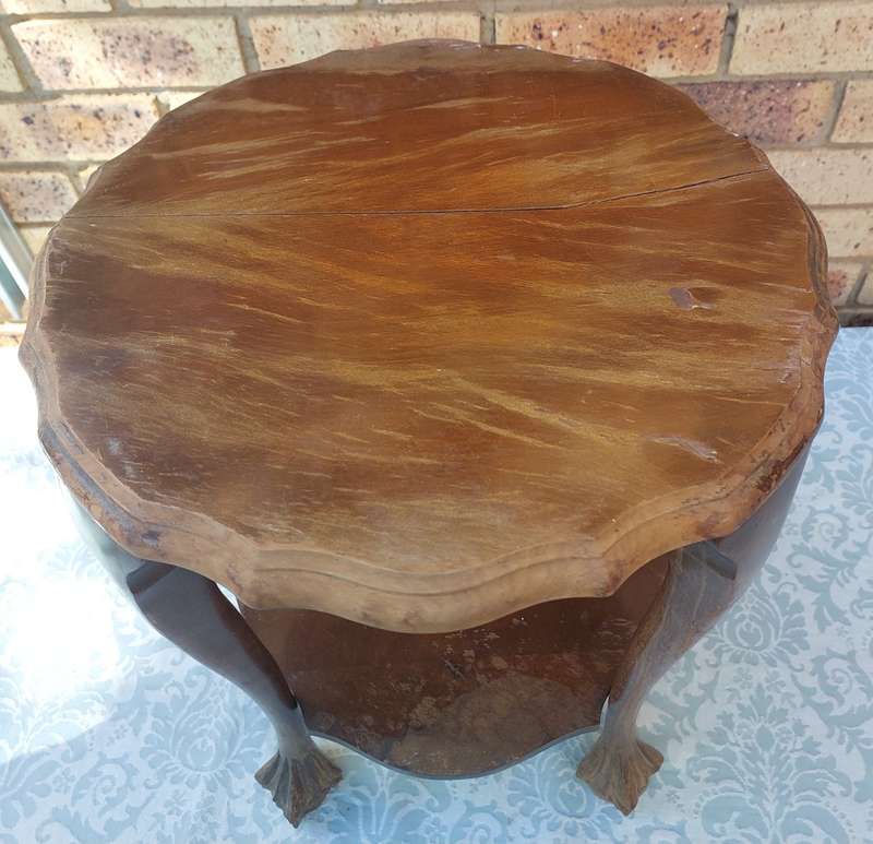 AN ANTIQUE SOLID WOOD TWO TEAR TEA TABLE WITH BALL N CLAW LEGS