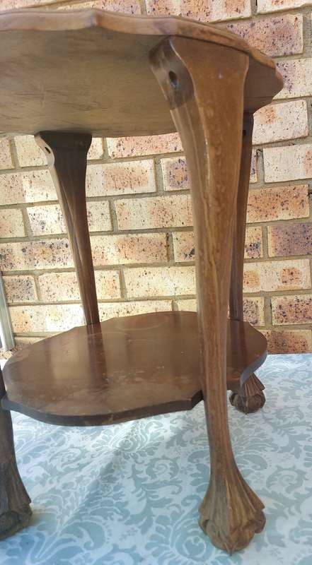 AN ANTIQUE SOLID WOOD TWO TEAR TEA TABLE WITH BALL N CLAW LEGS