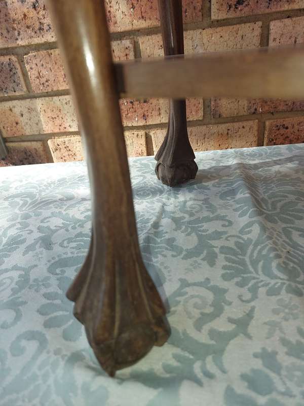 AN ANTIQUE SOLID WOOD TWO TEAR TEA TABLE WITH BALL N CLAW LEGS