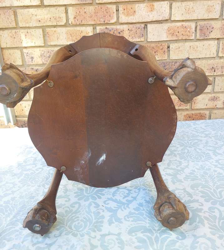 AN ANTIQUE SOLID WOOD TWO TEAR TEA TABLE WITH BALL N CLAW LEGS